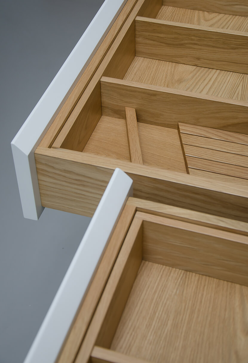 Bespoke kitchen handmade drawer boxes and inserts made from oak with spray lacquered  fronts and Silestone worktop. Bespoke joinery and cabinetry made in Whitstable, Kent.