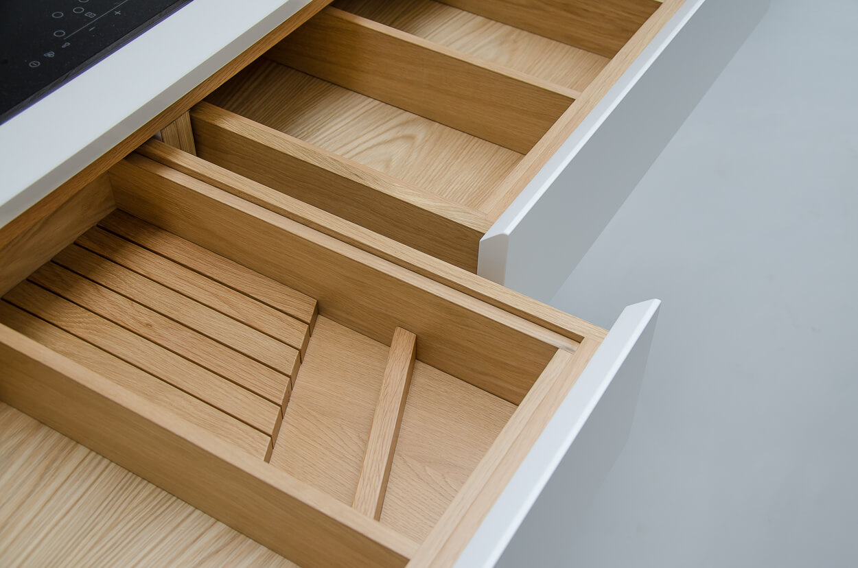 Bespoke kitchen handmade drawer boxes and inserts made from oak with spray lacquered  fronts and Silestone worktop. Bespoke joinery and cabinetry made in Whitstable, Kent.