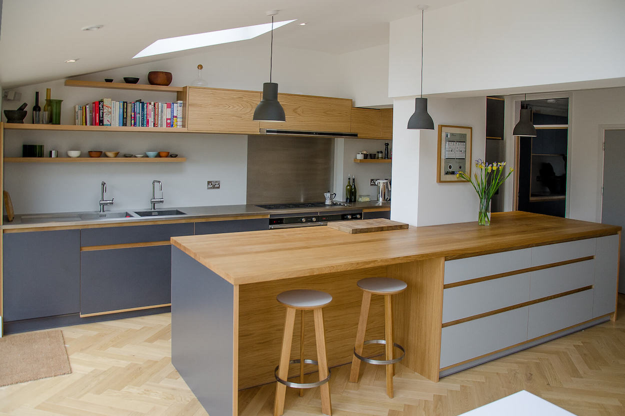 Cromwell rd bespoke handmade kitchen featuring birch plywood and oak doors finished in Fenix NTM laminate, oak detailing throughout and stainless steel worktop and oak island made in Kent.
